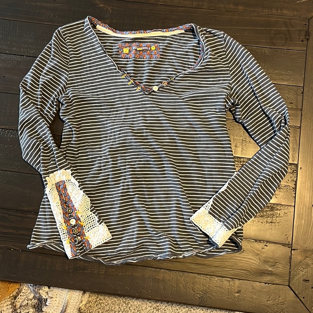 Cute striped tee with lace detailing.